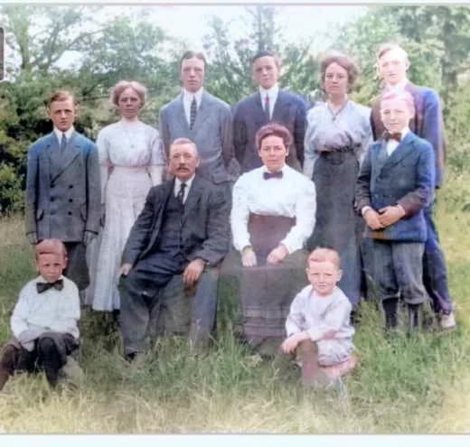 The John Joseph Coogan and Honora Manion family, early 1900s — Honora seated center-right in white, John Joseph seated center-left, with their children